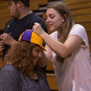 student signing another student's HSU hat