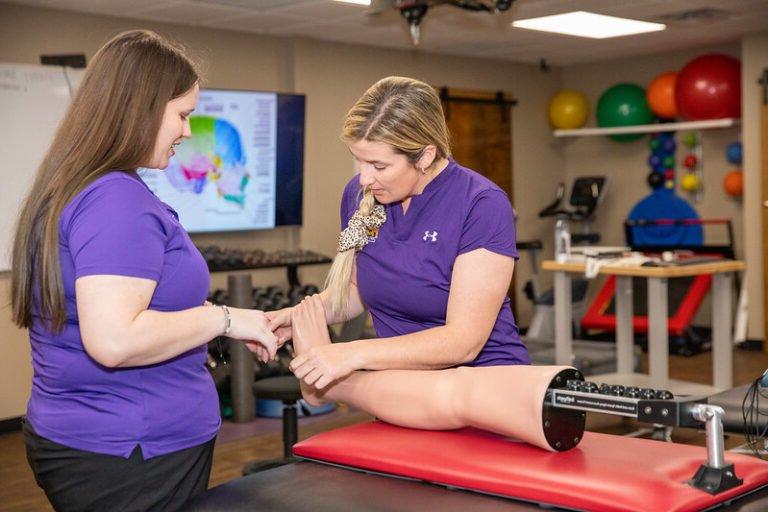 MAT students practice on a simulated limb.